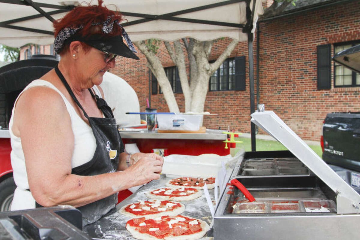 In this 2014 file photo, Teri Kilani cooks up a round of pizzas  during the Summer Sunday Lawn Concert series held at the Museum of the Southwest. Tyler White/Reporter-Telegram