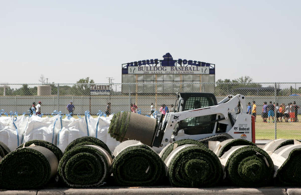 Workers pull up the turf at Memorial Stadium on Tuesday. James Durbin/Reporter-Telegram