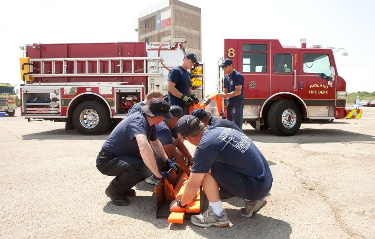 (File Photo) Midland Fire Department personnel familiarize themselves with the equipment on the new Station 8 fire engine at the MFD training grounds in this June 2011 file photo.  Cindeka Nealy/Reporter-Telegram