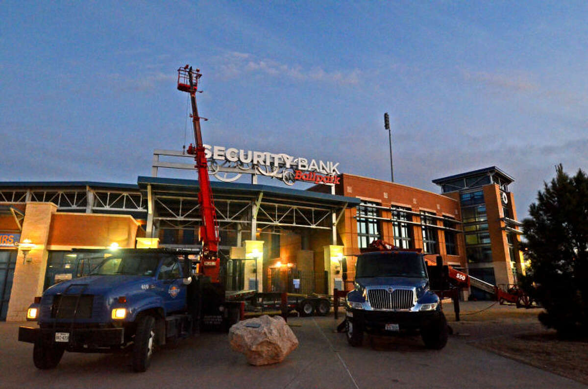Workmen hang parts of the new sign in front of Security Bank Ballpark on Tuesday. James Durbin/Reporter-Telegram