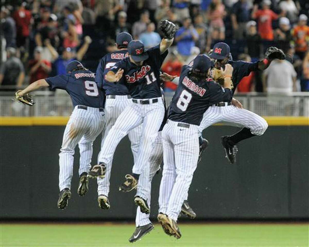Mississippi players celebrate their 6-4 win over TCU in an NCAA baseball College World Series elimination game in Omaha, Neb., Thursday, June 19, 2014. (AP Photo/Eric Francis)