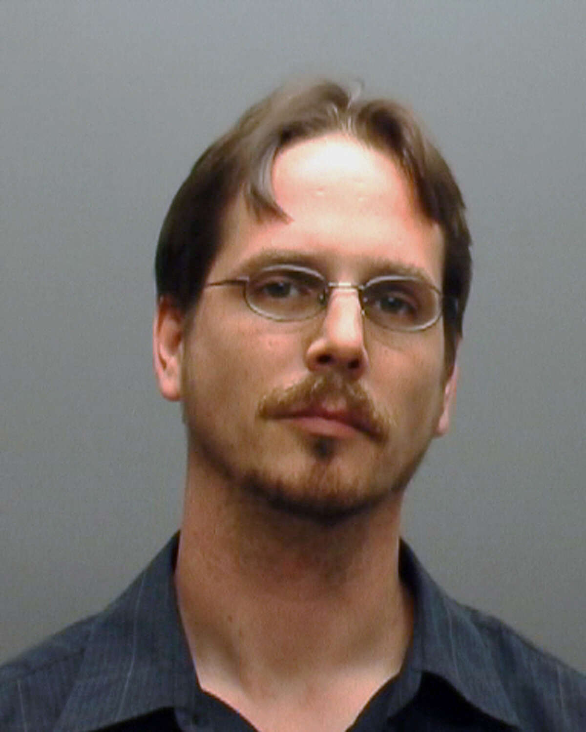 This booking photo provided by the Hays (Texas) County Sheriff shows Dane Thyssen. The Dripping Springs Police say Thyssen and his wife, Jenifer Thyssen kept their adopted son, 22-year-old Koystya Thyssen locked in a garage apartment for at least four years, periodically giving him a box of food and allowing him to leave once a week. Police began investigating when Koystya Thyssen was arrested for allegedly burglarizing a neighbor's home. (AP Photos/Hays County Sheriff)
