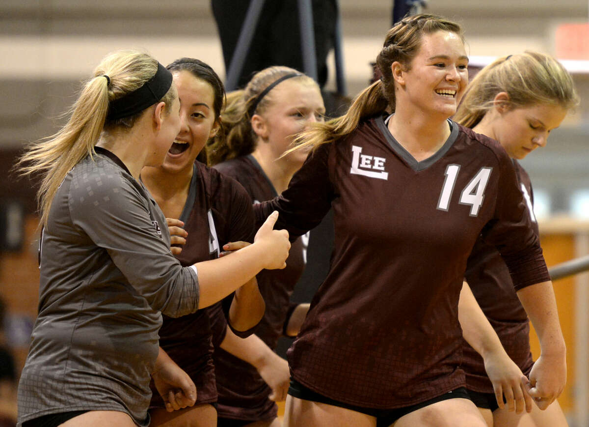 From left, Lee's Kelsey Olson (13), Shelby Olivas (4), Emily Hillman (9) and Darby O'Grady (14) celebrate after winning a match against Abilene Cooper on Tuesday, August 25, 2015, at Lee High. James Durbin/Reporter-Telegram