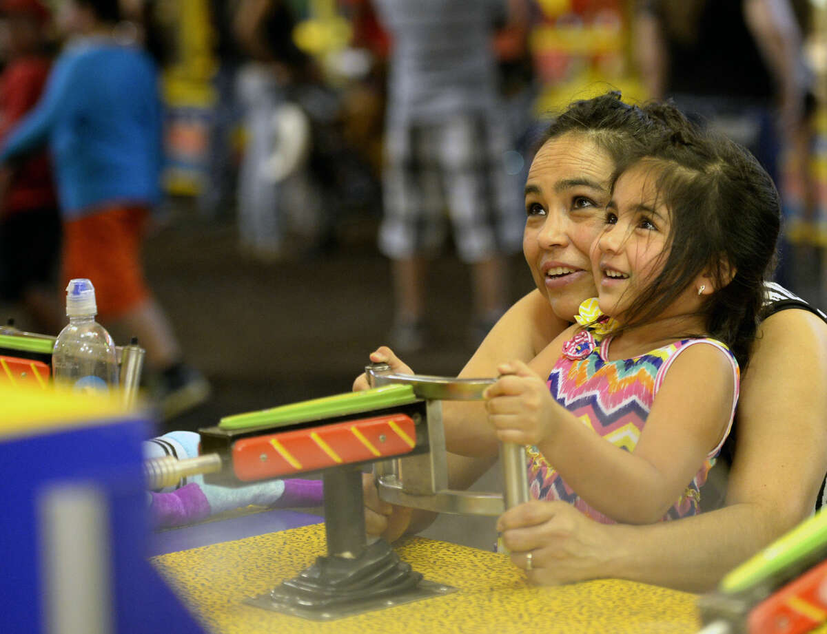 Susie Diaz and 4-year-old Zaida play a game at the Midland County Fair on Saturday, August 22, 2015 at Horseshoe Arena. James Durbin/Reporter-Telegram