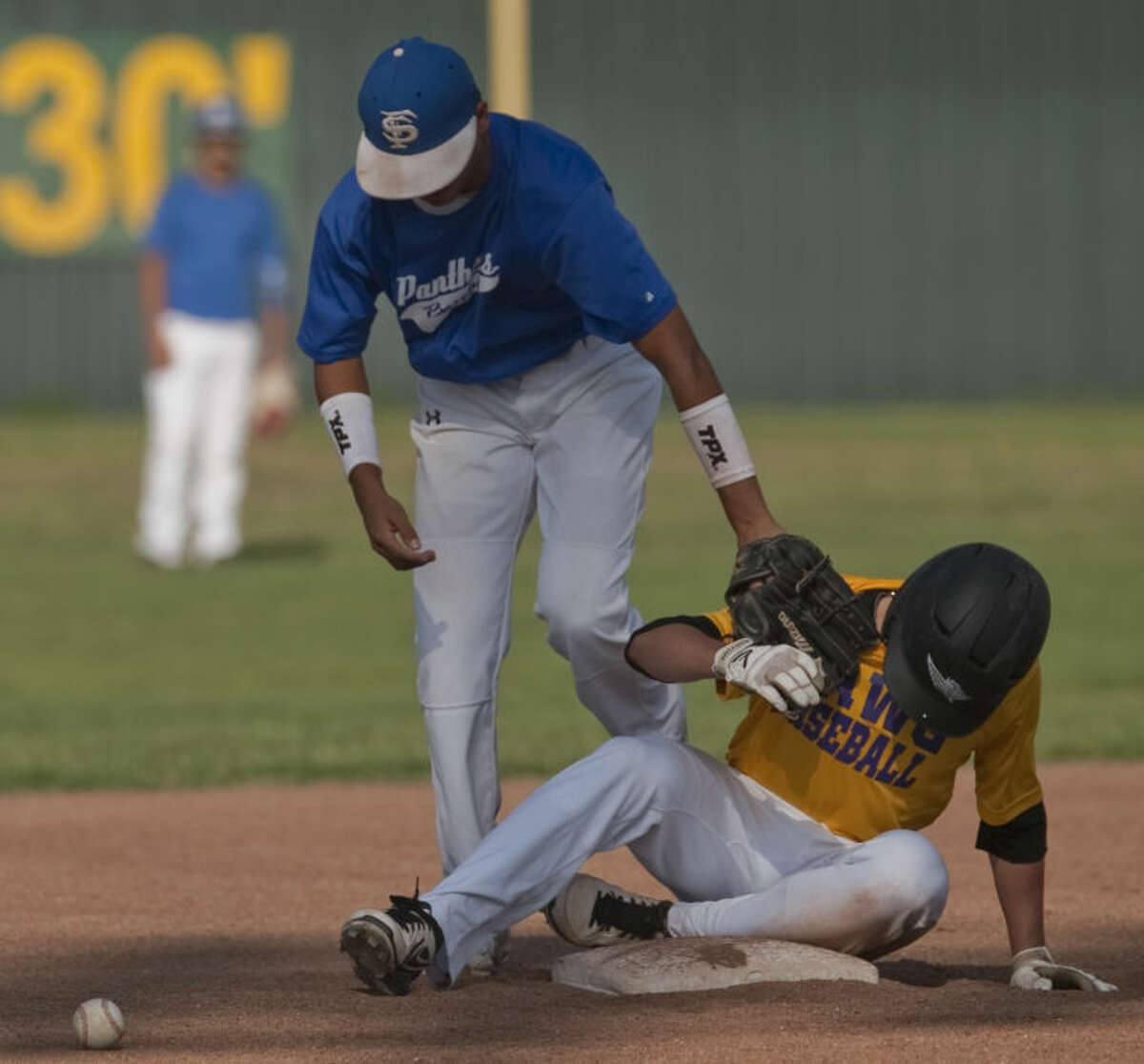 Midland's Josh Raies is safe for a double as Fort Stockton's Jay Castro drops the ball Monday in a Connie Mack Baseball game. Tim Fischer\Reporter-Telegram