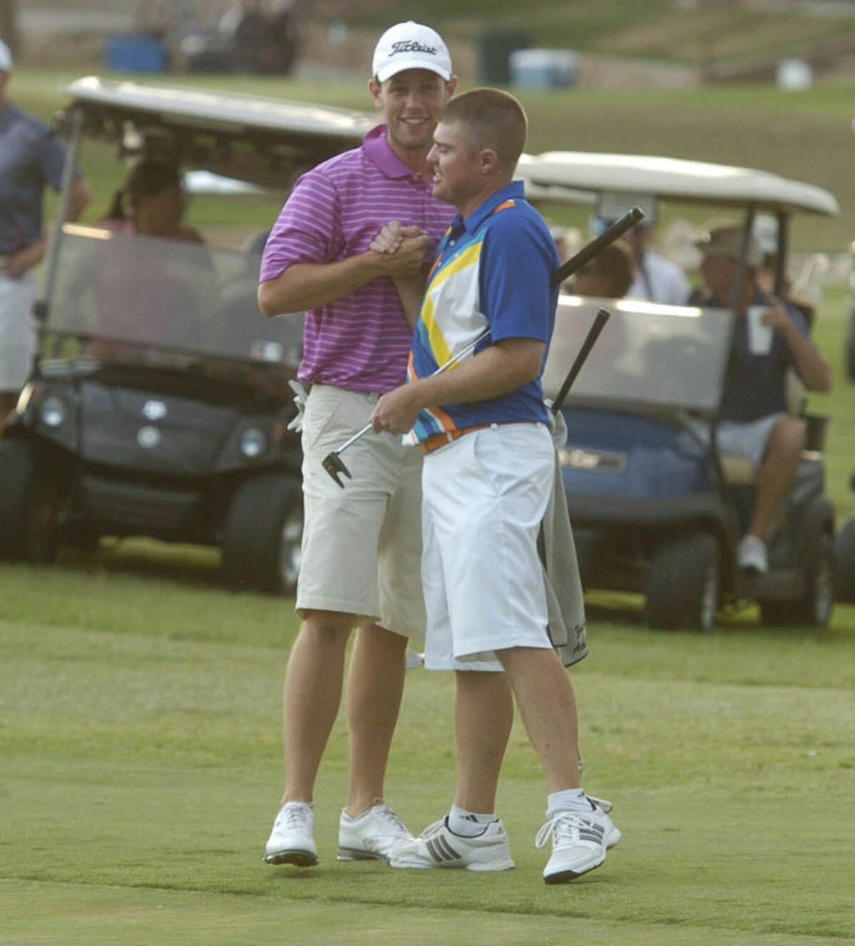Zach Atkinson, left, is congratulated by his partner Michael Pruitt, right, after the two clinched the 2013 Jamboree championship on the 18th hole on Sunday at Green Tree Country Club. The pair shot a 59 on the final day to win by two shots over Terene Begnel and Brady Shivers. Len Hayward/Reporter-Telegram
