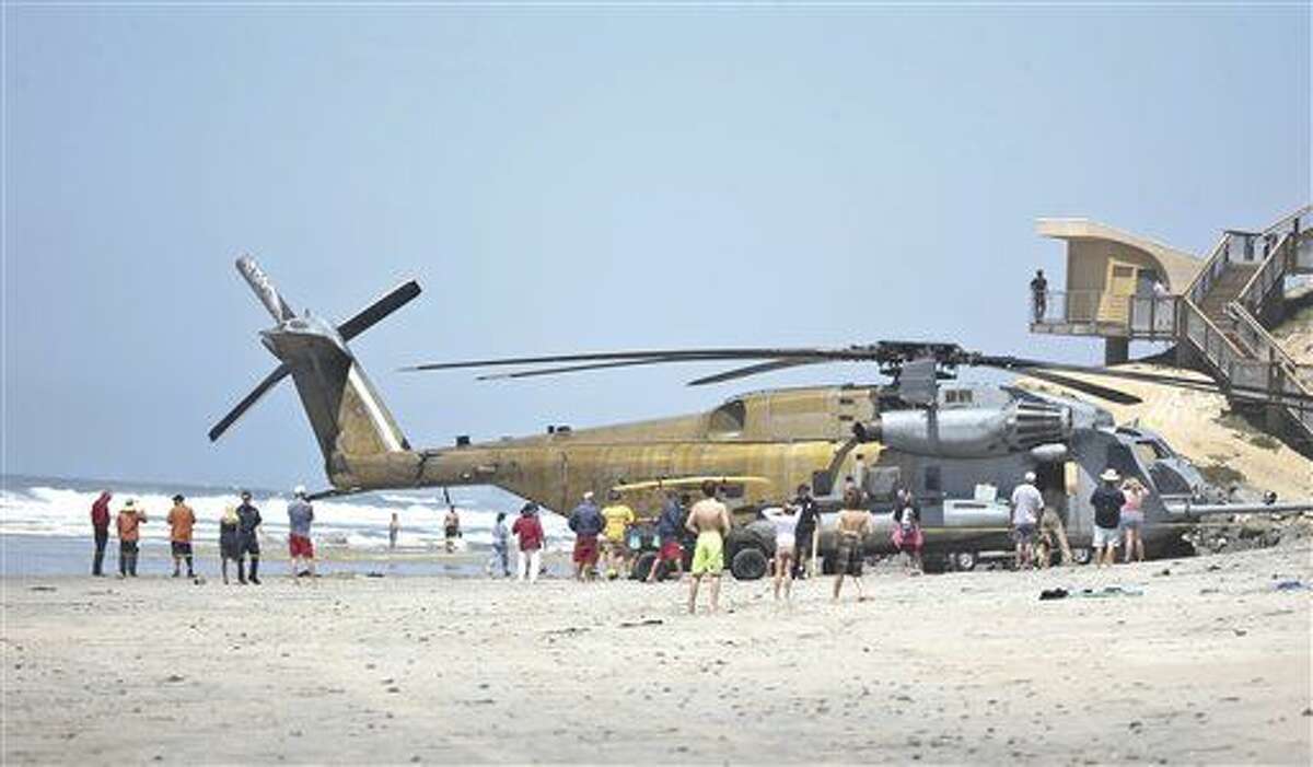 FILE -In this Wednesday, April 15, 2015 file photo, a Marine Corps CH-53E helicopter sits in the sand where it made an emergency landing in Solana Beach, Calif. One Marine has been killed and 9 others were hurt when a helicopter made a hard landing at Camp Lejeune in North Carolina, Wednesday night, Sept. 2, 2015. (AP Photo/Lenny Ignelzi, File)