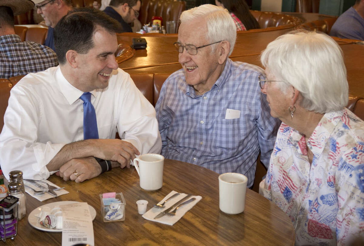 Presidential candidate Scott Walker sits to talk with Fariss Murphy from Odessa and Zaro Foster from Midland as well as other patrons at Lori's Cafe Friday 9-4-2015 morning in Midland. Tim Fischer\Reporter-Telegram