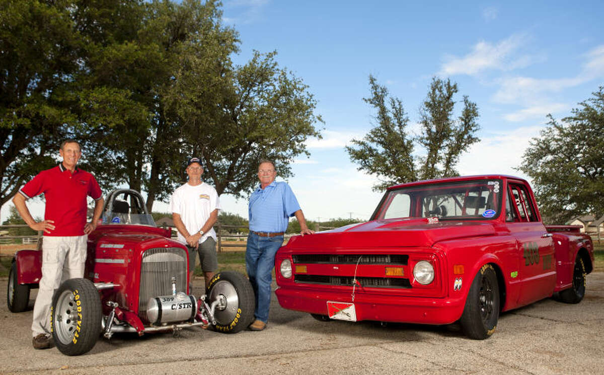 From left, Bruce Brady, Tom Kuhn and Oren Albright stand with their Bonneville salt flat racecars, a 1929 Ford powered by a 358 cubic inch Chevy engine and a 1969 Chevrolet C10 truck with a 305 cubic inch motor. James Durbin/Reporter-Telegram