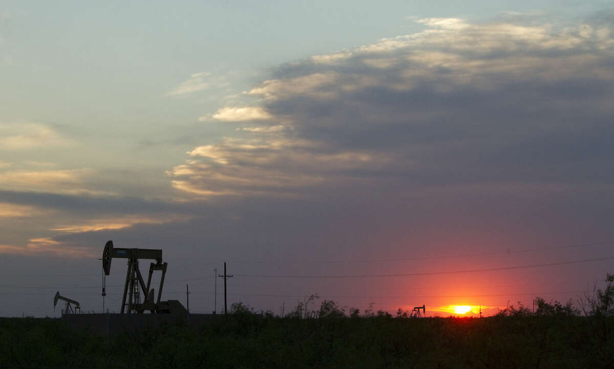 The sun sets behind a group of pump jacks Wednesday, June 1, 2011, outside of Midland. ( Brett Coomer / Houston Chronicle )