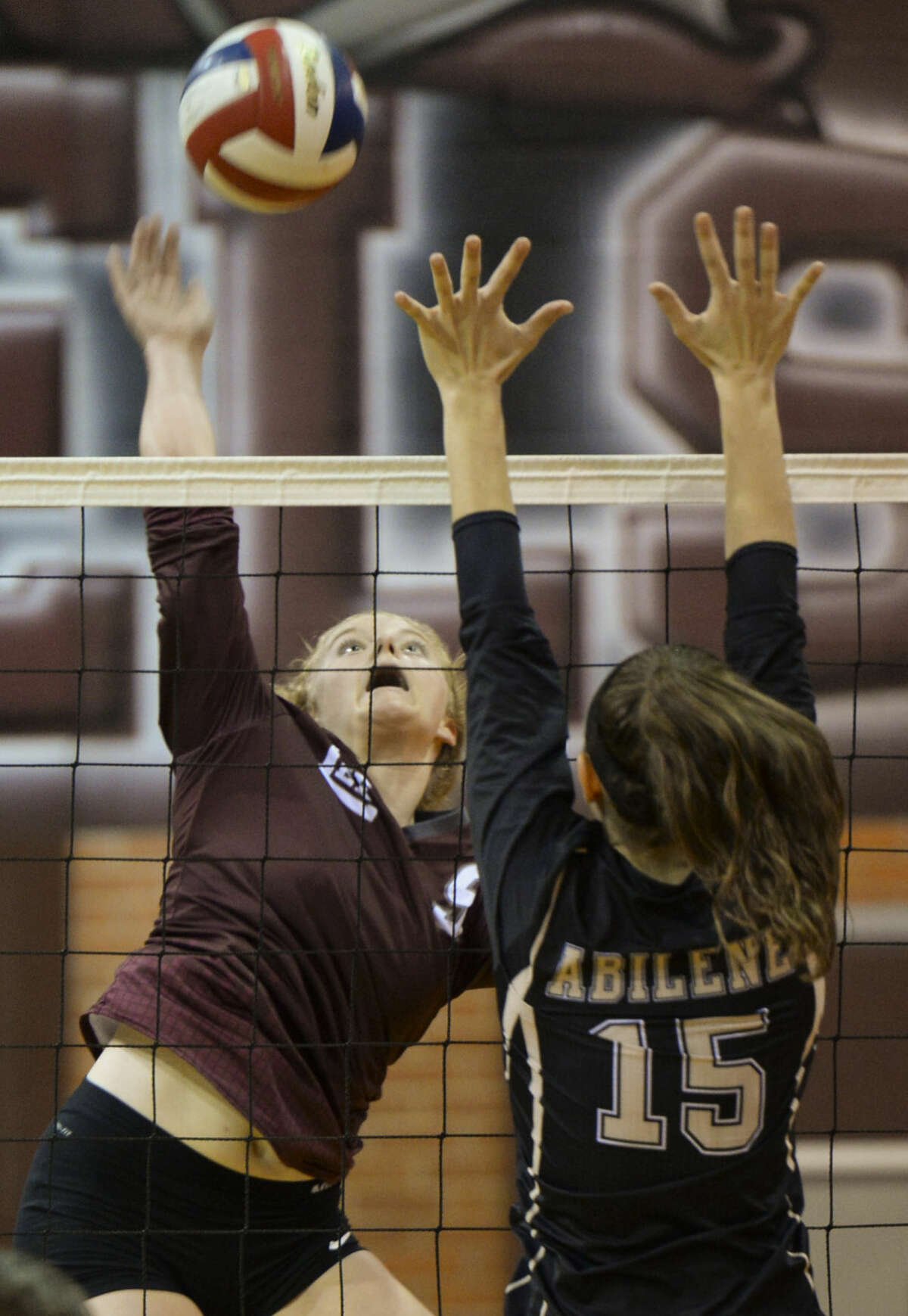 Lee High's Emily Hillman looks to spike the ball past Abilene High's London Moore Tuesday 10-6-2015 at Lee High. Tim Fischer\Reporter-Telegram