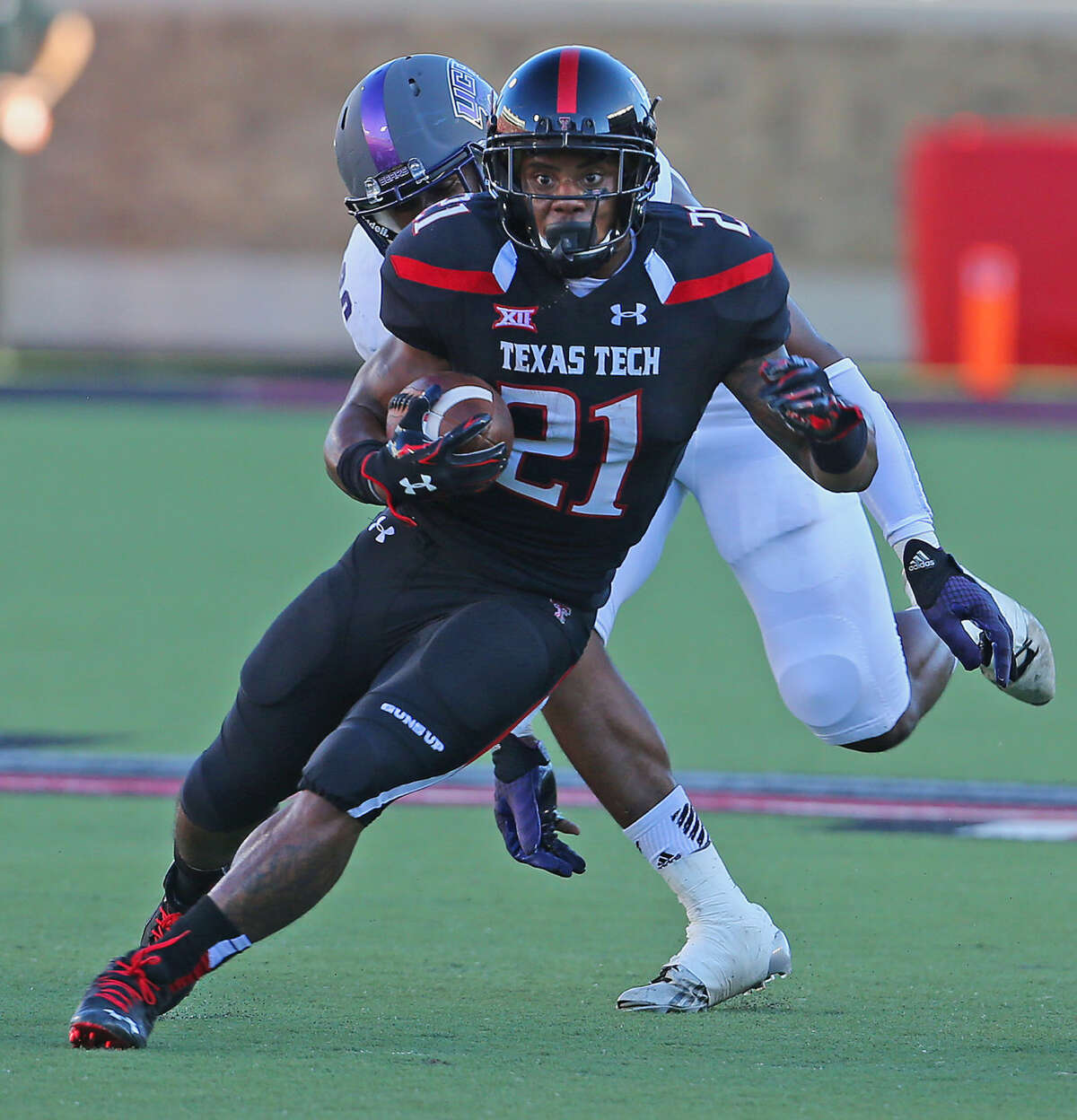 Texas Tech running back DeAndre Washington (21) runs through a huge hole in Saturday night action against the University of Central Arkansas.