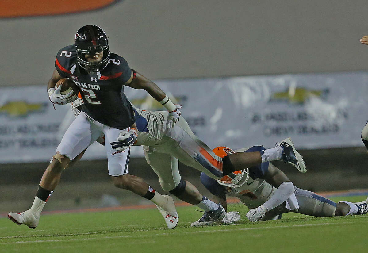 Red Raider receiver Reginald Davis tries to break free and gain more yards against the UTEP Miners.