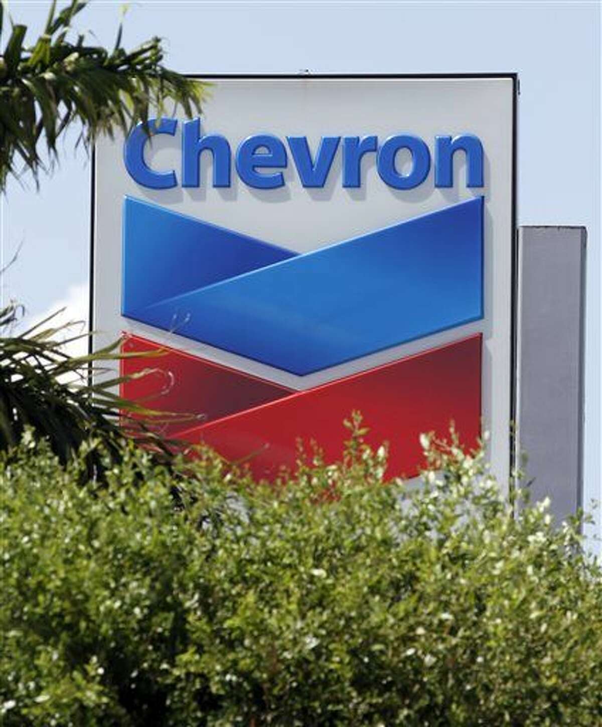 FILE - This Aug. 20, 2012 photo shows a Chevron sign in Miami. Chevron Corp. is cutting up to 7,000 jobs as it deals with lower oil prices that are cutting deeply into profit. The company said Friday, Oct. 30, 2015 that it would cut capital and exploratory spending next year by one-fourth, with further cuts in 2017 and 2018 depending on the oil industry's condition then. (AP Photo/Alan Diaz)
