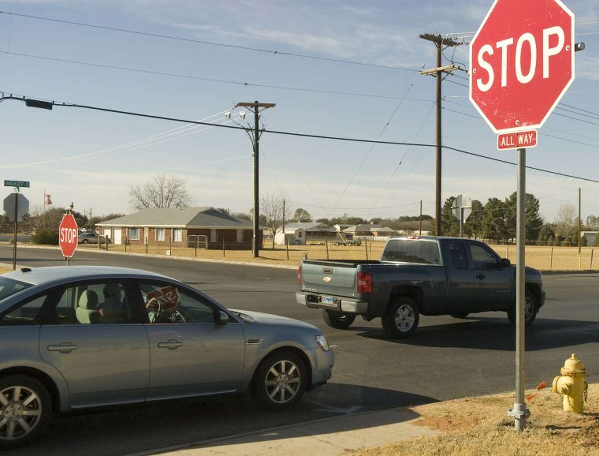 In this 2010 file photo, drivers pass through a four-way stop intersection at Midkiff Road and Bluebird Lane. Bynum Schools parents are pushing for a similar four-way stop intersection at Highway 158 and County Road 60.
