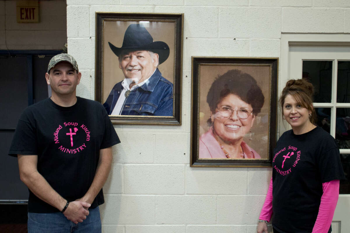 Jason and Nancy Ivy stand next to portraits of her parents Mariano and Mary Rendon who started the Midland Soup Kitchen. Nancy has now taken over the task of running the nonprofit.