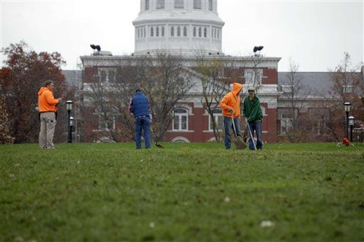 University of Missouri grounds maintenance workers begin to clean up Mel Carnahan Quad on the University of Missouri campus Wednesday, Nov.11, 2015, in Columbia, Mo. The Concerned Student 1950 activist group tent city was disassembled overnight after both the University system president and the chancellor resigned. (John Happel/Columbia Missourian via AP)