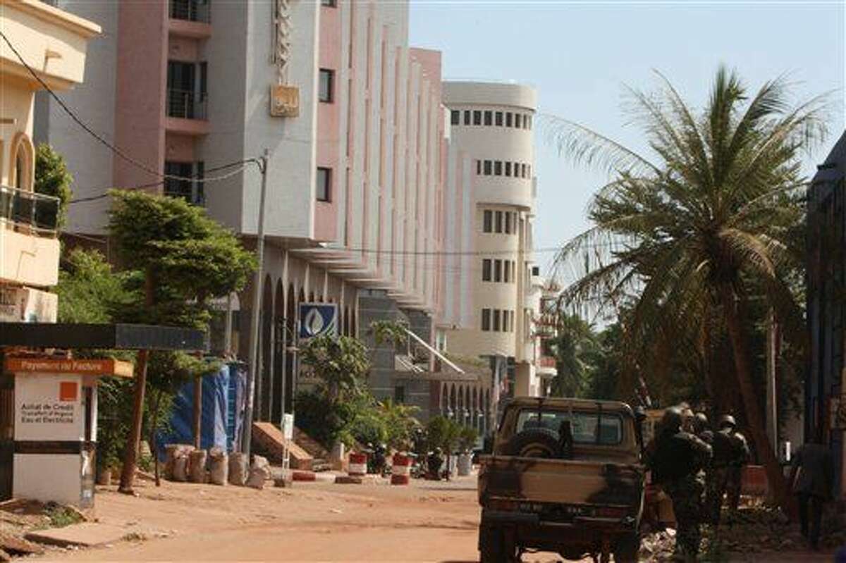 The Radisson Blu hotel, left, that was stormed by gunmen during an attack on the hotel in Bamako, Mali, Friday, Nov. 20, 2015. Islamic extremists armed with guns and throwing grenades stormed the Radisson Blu hotel in Mali's capital Friday morning, killing at least three people and initially taking numerous hostages, authorities said. (AP Photo/Harouna Traore)