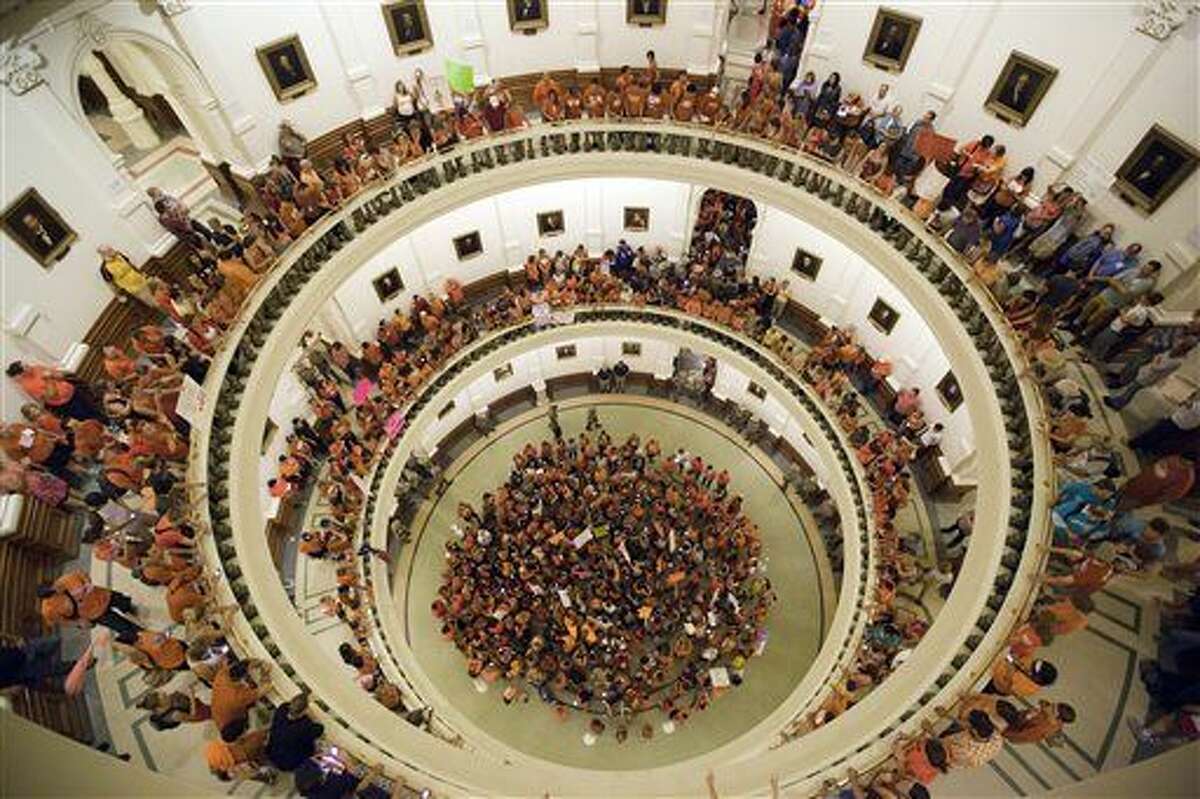 FILE - In this July 12, 2013 file photo, abortion rights advocates fill the rotunda of the State Capitol as Texas senators were wrapping up debate on sweeping abortion restrictions and were poised to vote on a measure after weeks of protests.