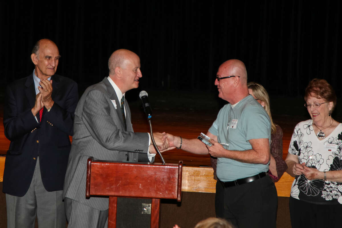 Danny Holeva, executive director of Arts Council of Midland, left, congratulates Michael Fields after the Midland Community Theatre volunteer was named Volunteer of the Year Tuesday at the council’s annual meeting. Looking on are volunteers Tom Hyde, far left, and Julia Still, far right.