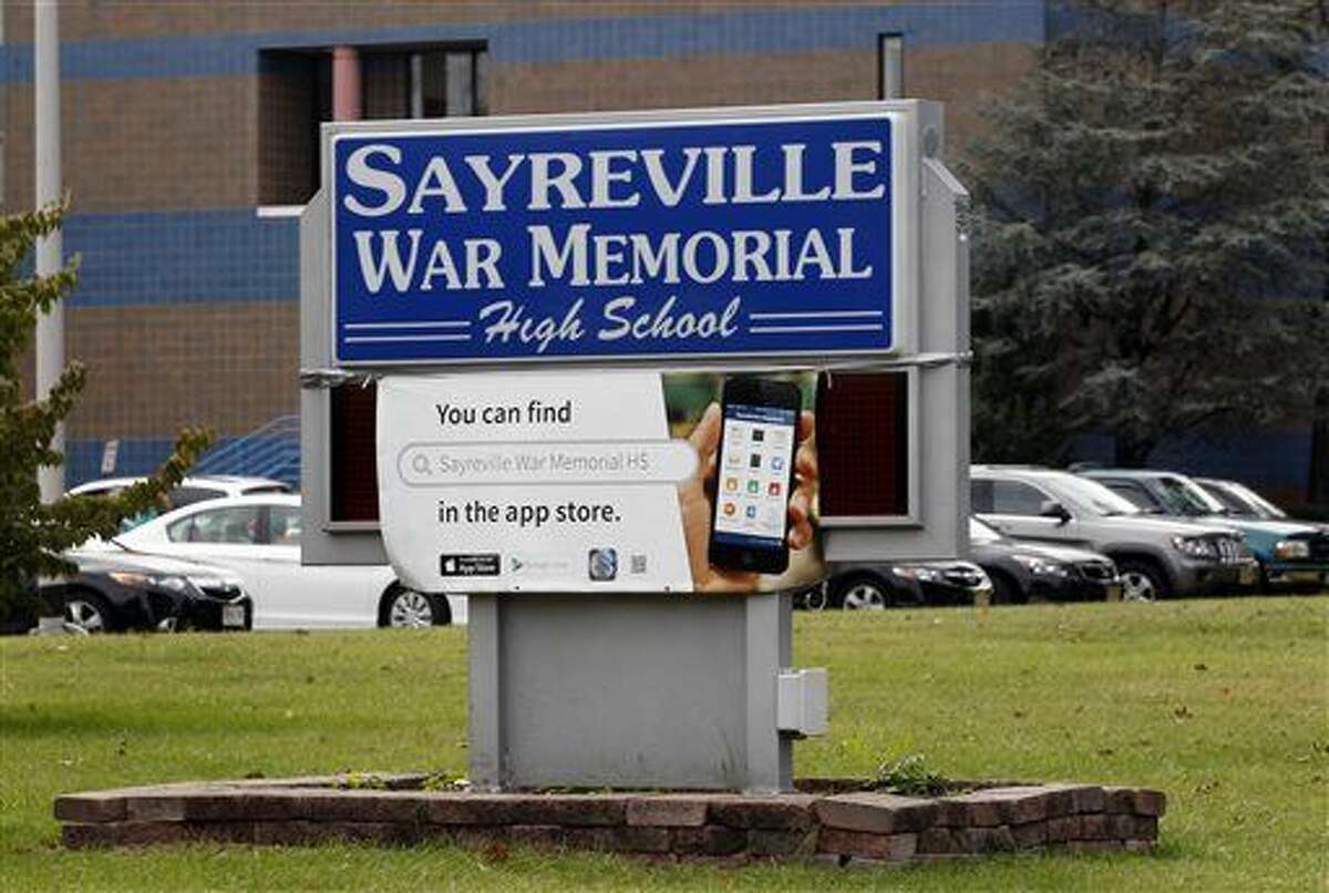 The entrance to Sayreville War Memorial High School is shown Tuesday, Oct. 7, 2014, in Sayreville, N.J. Officials at a school, which has won three sectional titles over the past four years, canceled the football season amid allegations of harassment, intimidation and bullying among players. (AP Photo/Mel Evans)