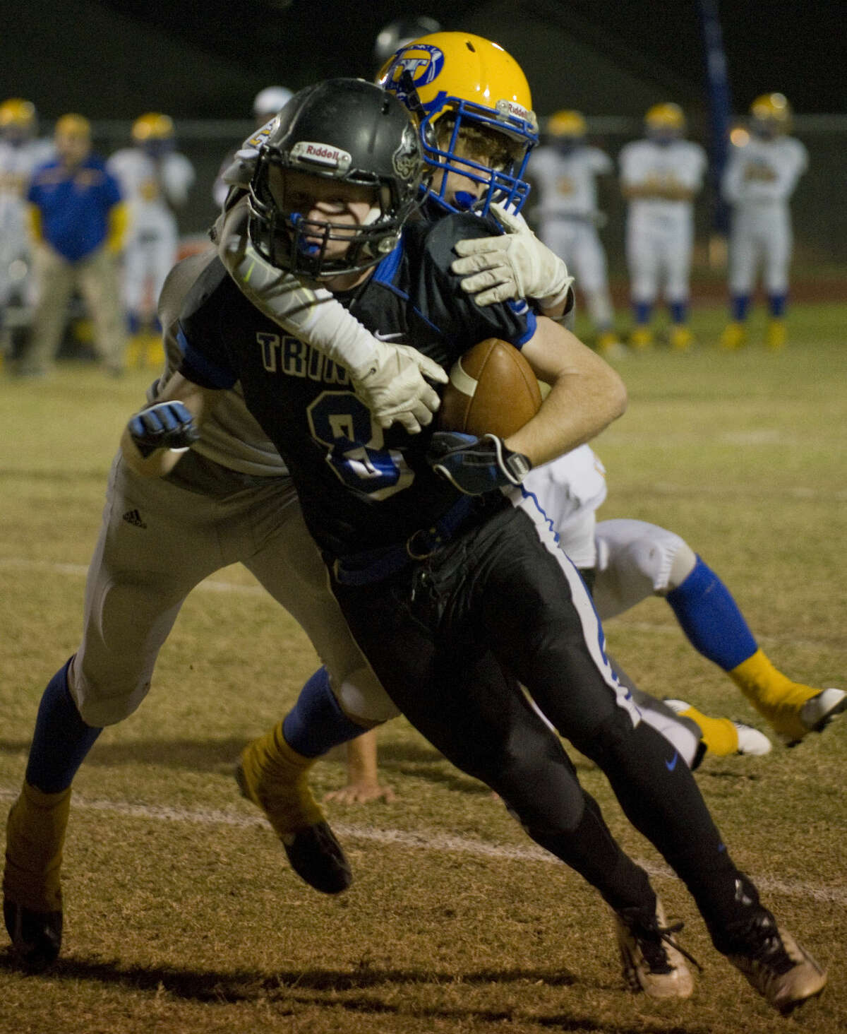 Trinity's Peyton Harrington tries to gain more yardage as Dallas Lutheran's Cody Patterson hangs on Friday 11-6-2015 at Coombes Field. Tim Fischer\Reporter-Telegram