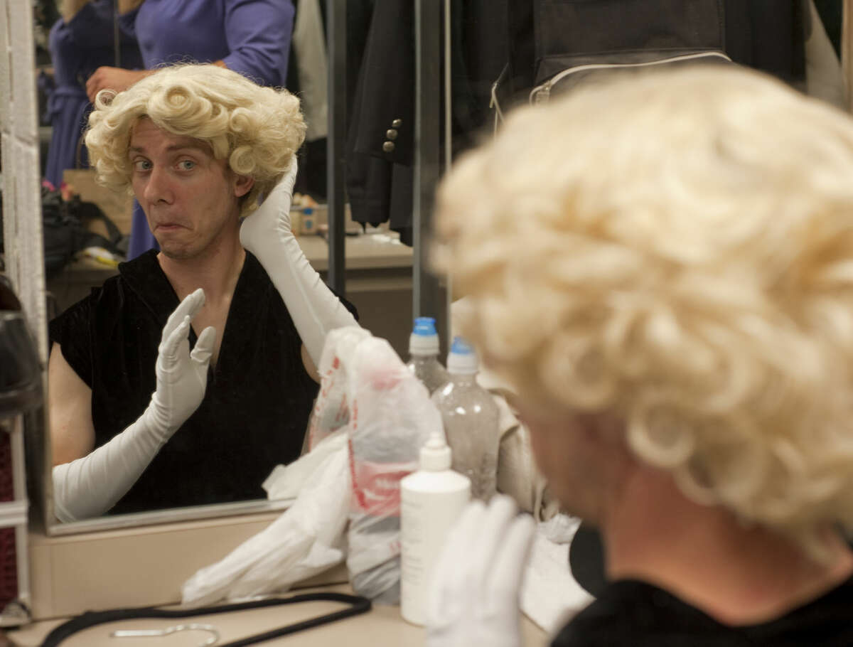 Ben Spencer checks his wig in a mirror as he gets readying for rehearsal in MCT's production of Leading Ladies.