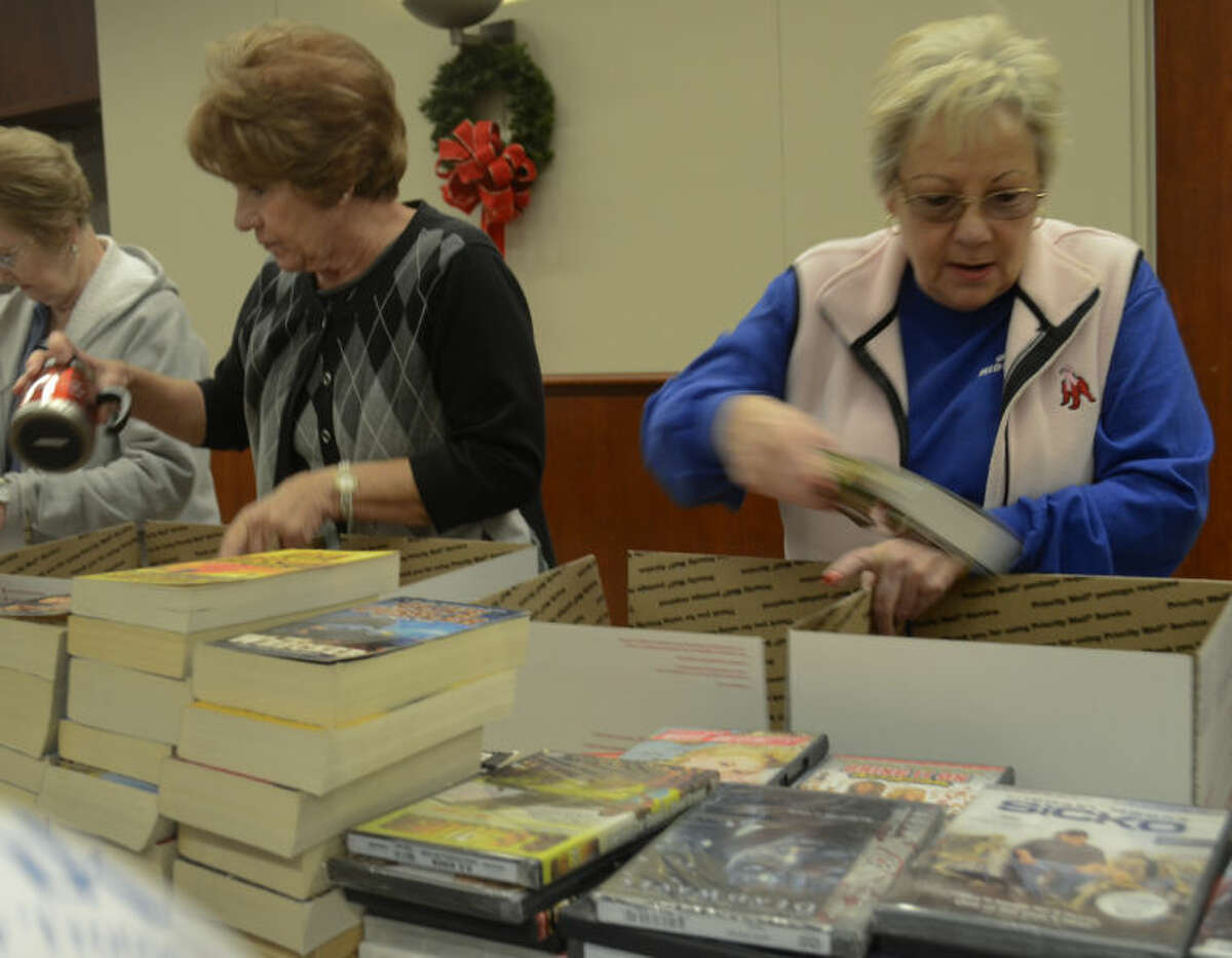 Ann Carter, Sharlene Maddocks and other volunteers help pack goodies into boxes at the 10th annual Christmas for Our Troops. Tim Fischer\Reporter-Telegram