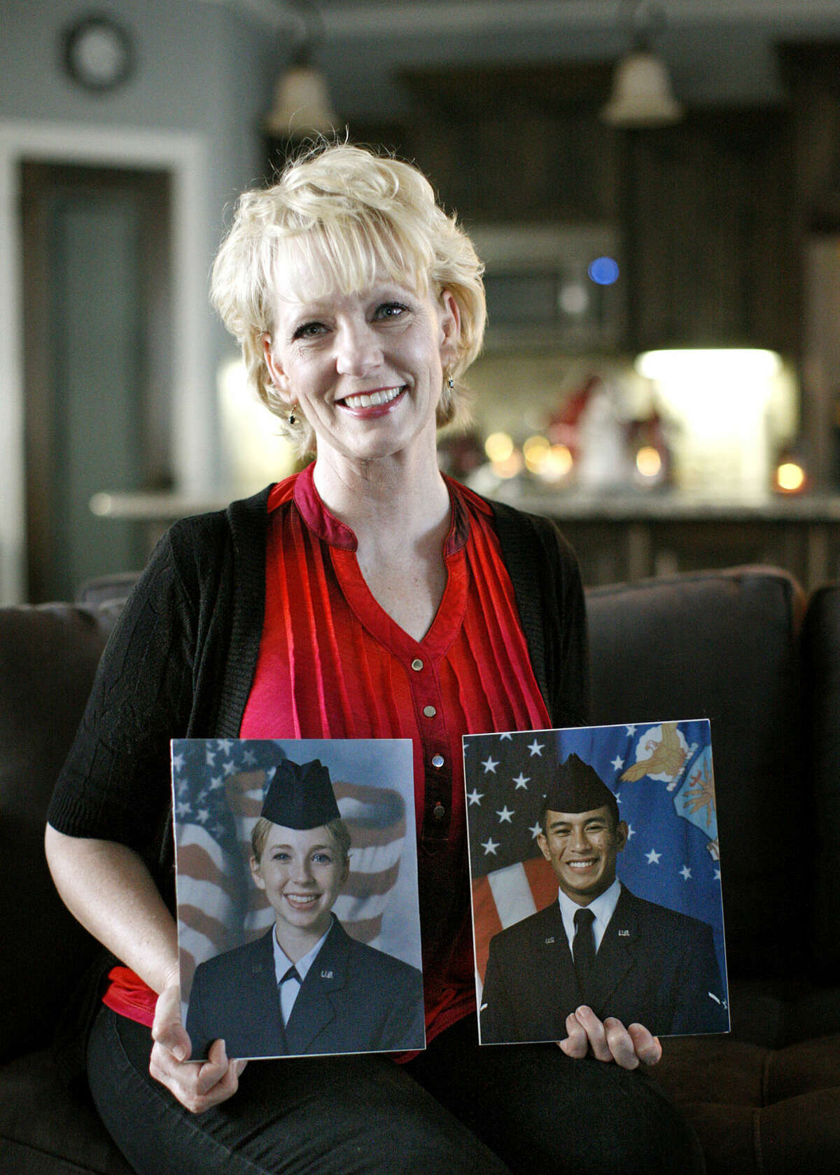 Stephanie Harper, a US Air Force veteran, poses with pictures of her son and daughter who are also veterans of the USAF, on Friday, Dec. 4, 2015, at her home in west Midland. James Durbin/Reporter-Telegram