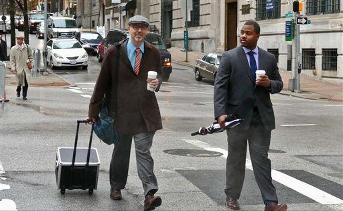 Baltimore City police officer William Porter, right, one of six Baltimore police officers charged with the death of Freddie Gray, walks to courthouse East with one of his attorneys on Wednesday, Dec. 2, 2015 in Baltimore. Porter faces charges of involuntary manslaughter, second-degree assault, misconduct in office and reckless endangerment. The charges carry maximum prison terms totaling about 25 years. (Kevin Richardson/The Baltimore Sun via AP) WASHINGTON EXAMINER OUT; MANDATORY CREDIT