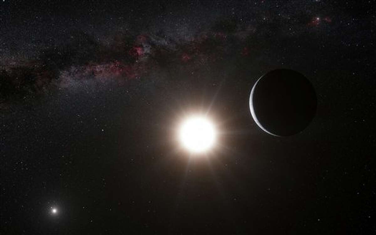 This artist’s impression made available by the European Southern Observatory on Tuesday, Oct. 16, 2012 shows a planet, right, orbiting the star Alpha Centauri B, center, a member of the triple star system that is the closest to Earth. Alpha Centauri A is at left. The Earth's Sun is visible at upper right. Searching across the galaxy for interesting alien worlds, scientists made a surprising discovery: a planet remarkably similar to Earth in a solar system right next door. Other Earth-like planets have been found before, but this one is far closer than previous discoveries. Unfortunately, the planet is way too hot for life, and it’s still 25 trillion miles away. (AP Photo/ESO, L. Calcada)