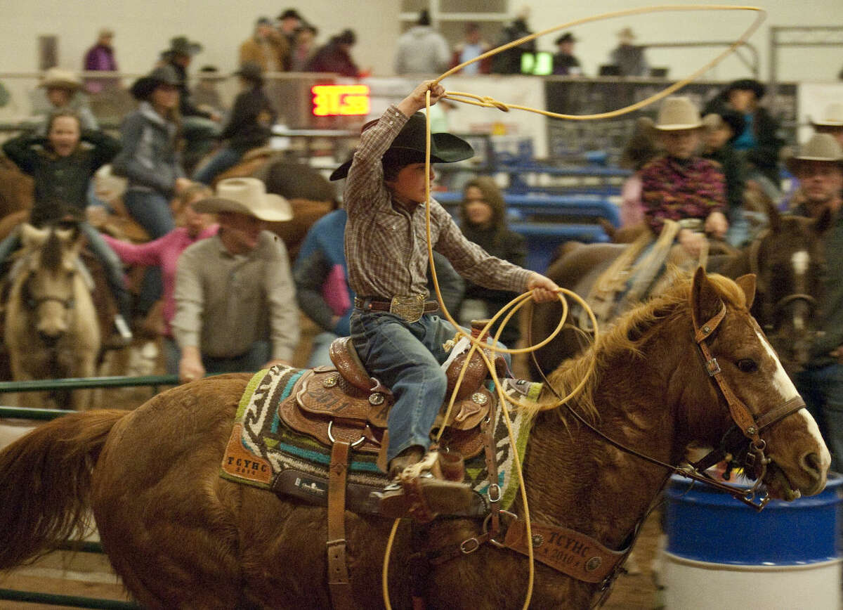 12-30-14 Brayden Cervantes chases a calf Tuesday afternoon at the New Year's Calf Roping Blowout at the Horseshoe Arena. Tim Fischer\Reporter-Telegram