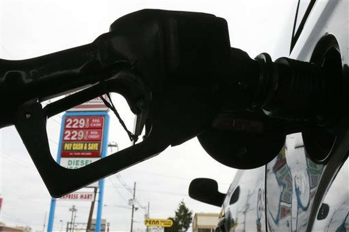 FILE - In this Dec. 18  file photo, gas is pumped into a car at the Eastcoast filling station in Pennsauken N.J.  (AP Photo/Matt Rourke, File)