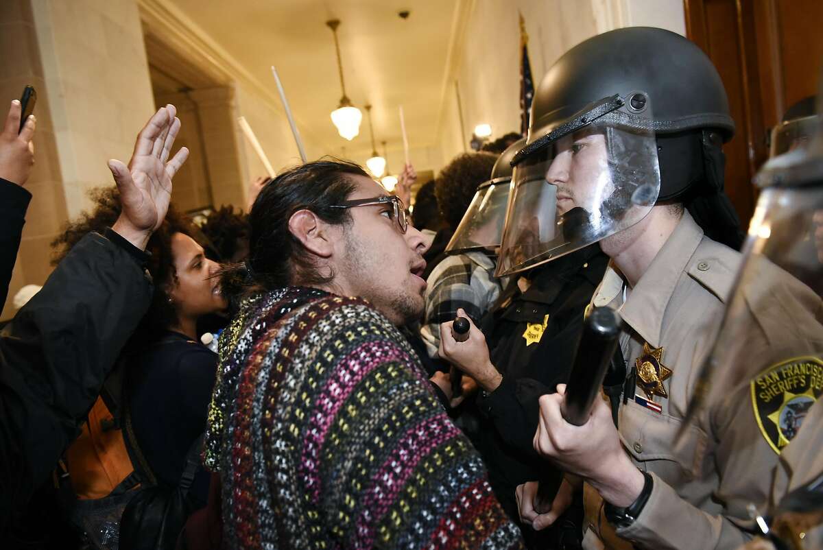 Protesters supporting the "Frisco Five" hunger strikers clash with police officers in front of the mayors office at City Hall in San Francisco in San Francisco, CA, Friday, May 6, 2016.