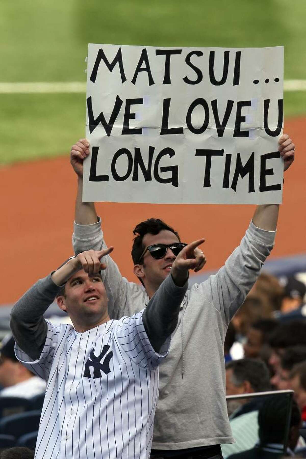 NEW YORK - APRIL 13: Fan of Hideki Matsui hold up a sign readiing "Matsui We Love U Long Time" as the New York Yankees play against the Los Angeles Angels of Anaheim during the Yankees home opener at Yankee Stadium on April 13, 2010 in the Bronx borough of New York City. (Photo by Chris McGrath/Getty Images)