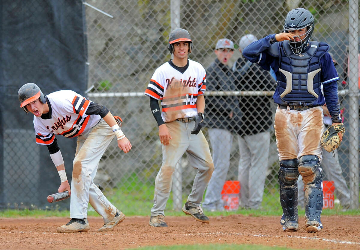 Stamford Jay DeVito (2) andDanny Collazo (10) celebrate scoring the go ahead runs in the botton of the fifth inning of a baseball game against Wilton in Stamford on Saturday, May 7, 2016. The Black Knight dou scored on an throwing error to first base in attempt to get batterJorge Lopez out. At right is Wilton catcher Jack DiNanno.