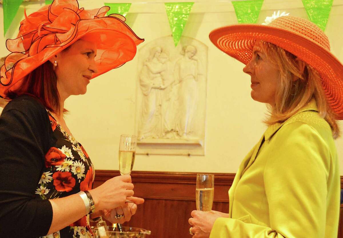 Michelle Adams, left, and Kristen Adams, both of Fairfield, are not related but became fancy-hat friends at the Derby Day celebration hosted by the Pequot Library.