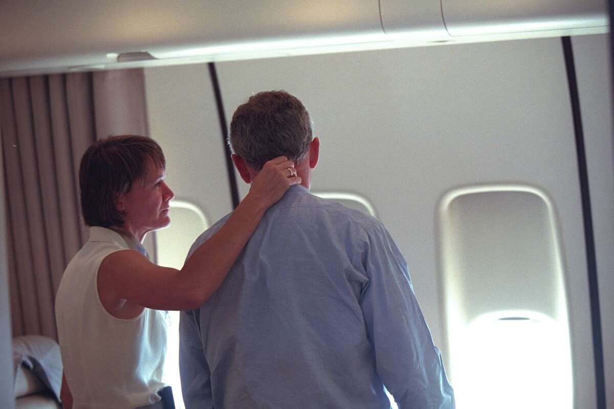 The president is consoled by Lt. Col. Cindy Wright of the White House Military Office aboard Air Force One. After leaving Louisiana, the president was flown to Offutt Air Force Base in Nebraska before he headed back to Washington D.C. Via PBS.