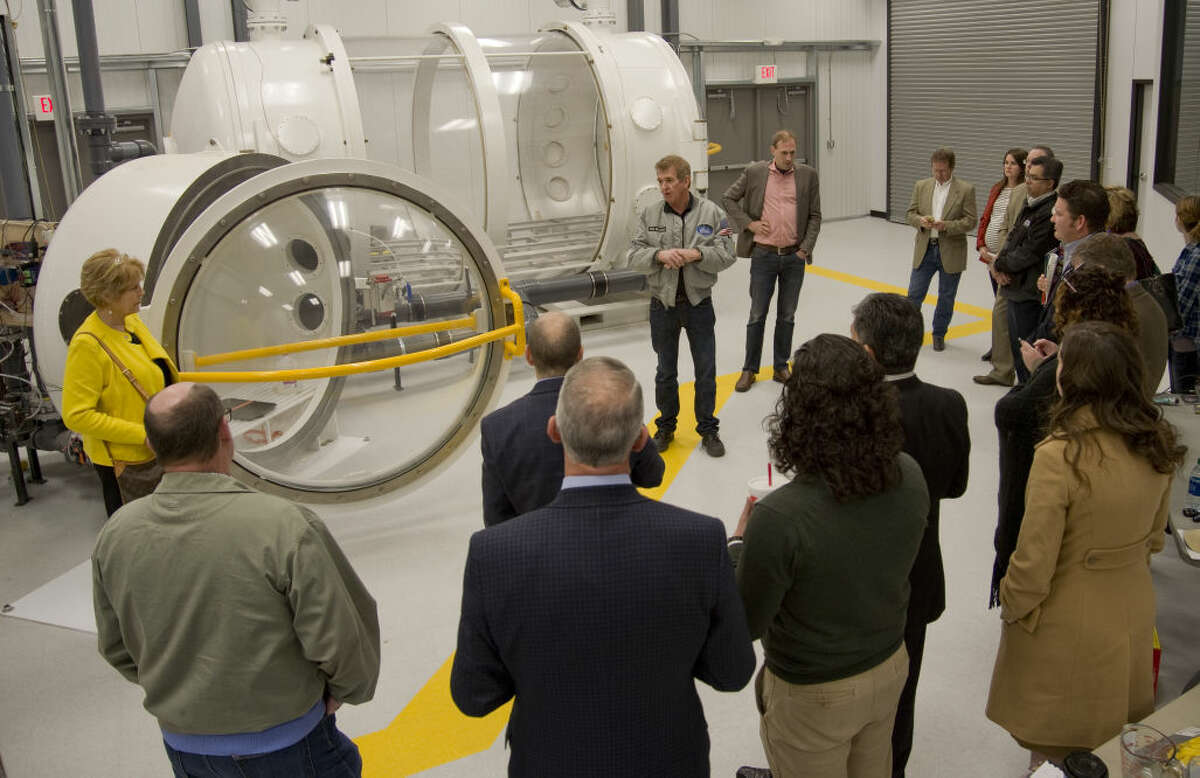 FILE PHOTO: Dennis Gilliam with Orbital Outfitters, talks about the new pressure chambers as members of the MDC board tour the Orbital Outfittes facility Friday 01-29-16, watching a demonstration of the pressure chamber and the affect on water in a low pressure atmosphere. The MDC voted unanimously to terminate its agreement with Orbital Outfitters, a space suit startup company headquartered at Midland International Air & Space Port. 