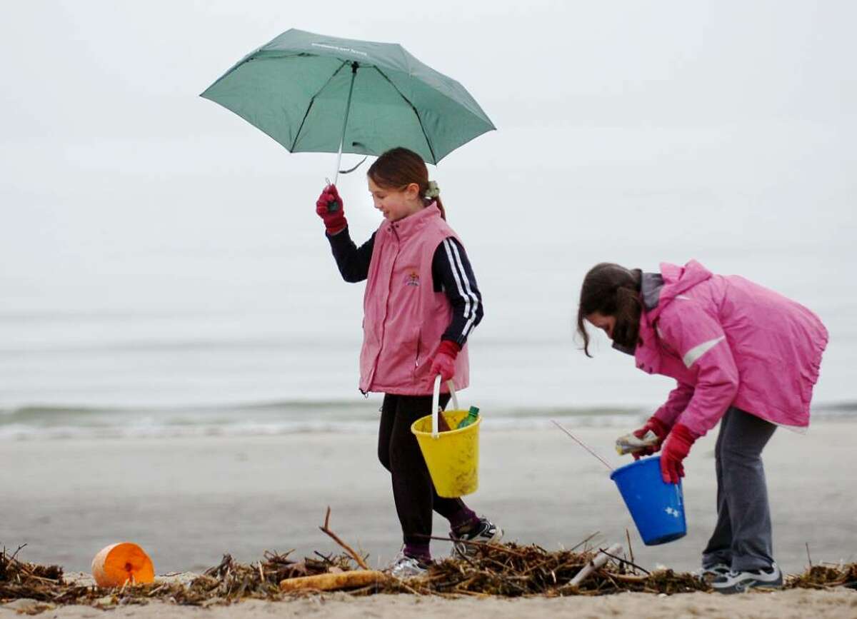 Girl Scouts from Troop 50650 of Old Greenwich, Olivia Dallape, 10, left, and Talia Newman, also 10, clear the beach at Greenwich Point of garbage during the Greenwich Green & Clean's annual townwide cleanup, Saturday morning, April 17, 2010.