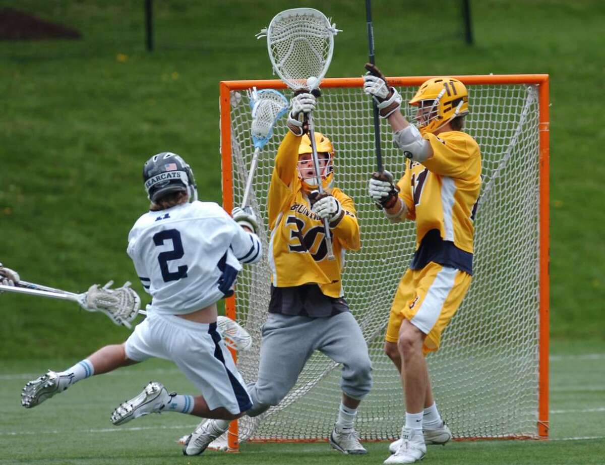 Jack Rogan, Brunswick goalie, stops a point-blank shot by Pierson Fowler, # 2, during lst quarter action of game against Hotchkiss, at Brunswick, Saturday, April 17, 2010. At right is Brunswick's Philip Pierce.