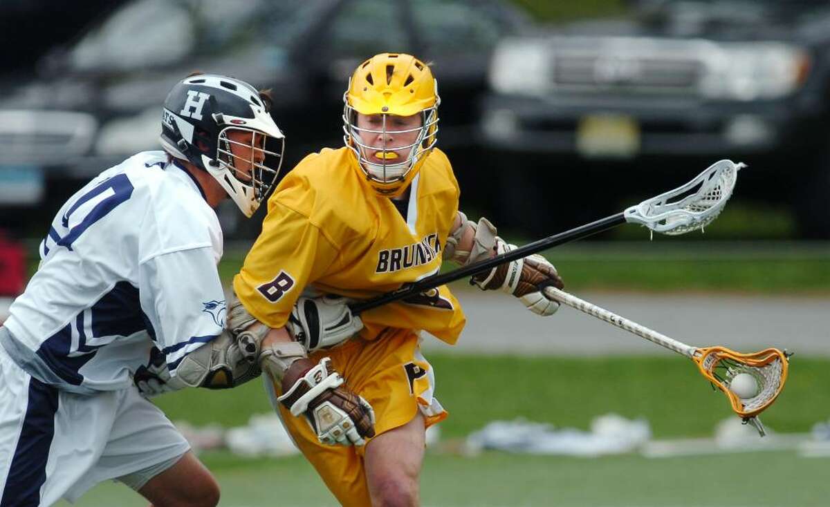 Bo Stafford, # 6 of Brunswick, right, attempts to turn the corner against a Hotchkiss defender, Tripper Gandy, during lst quarter action of game between Brunswick and Hotchkiss, at Brunswick, Greenwich, Conn., April 17, 2010.