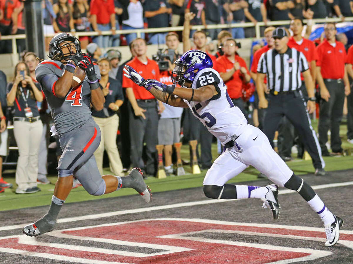 Texas Tech wide receiver Bradley Marquez (4) hauls in the winning Touchdown against the TCU Horned Frogs in Thursday night Big XII action at Jones A T & T stadium. MArquez' Raiders won the contest 20-10.