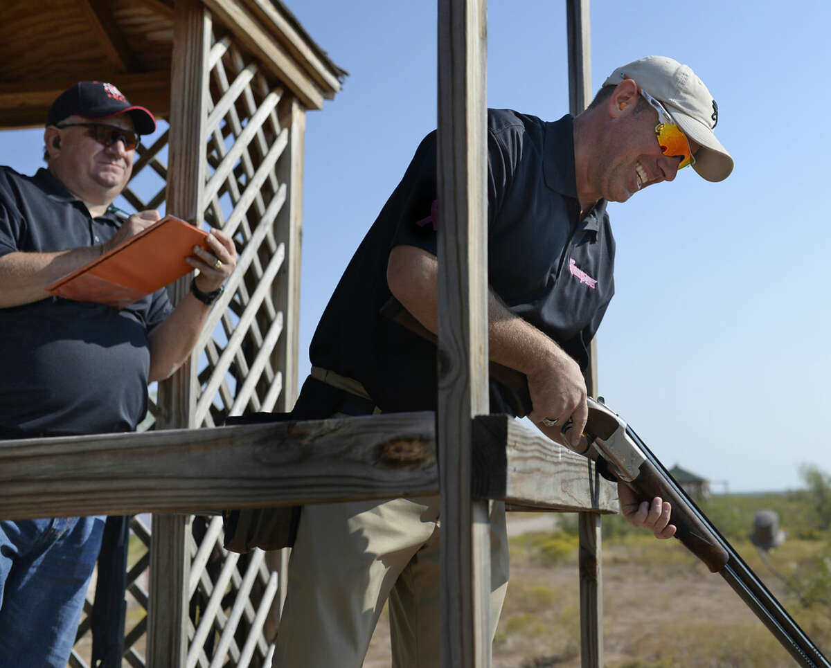 Jay Young with Renegade Wireline reloads his Browning after shooting at true pairs while Charlie Newsome, also with Renegade, keeps score during the Boys and Girls Club fundraiser on Friday, Sept. 2, 2015 at Jake's Clays. The event raised more than $65,000 after expenses according to David Chancellor, executive director for Boys and Girls Clubs of the Permian Basin. "Our goal is to make our services available to kids who need us most," said Chancellor, "events like this allow us to keep our services almost free so we don't have to exclude a child." The Boys and Girls Clubs in the Permian Basin serve more than 4000 kids each year. James Durbin/Reporter-Telegram