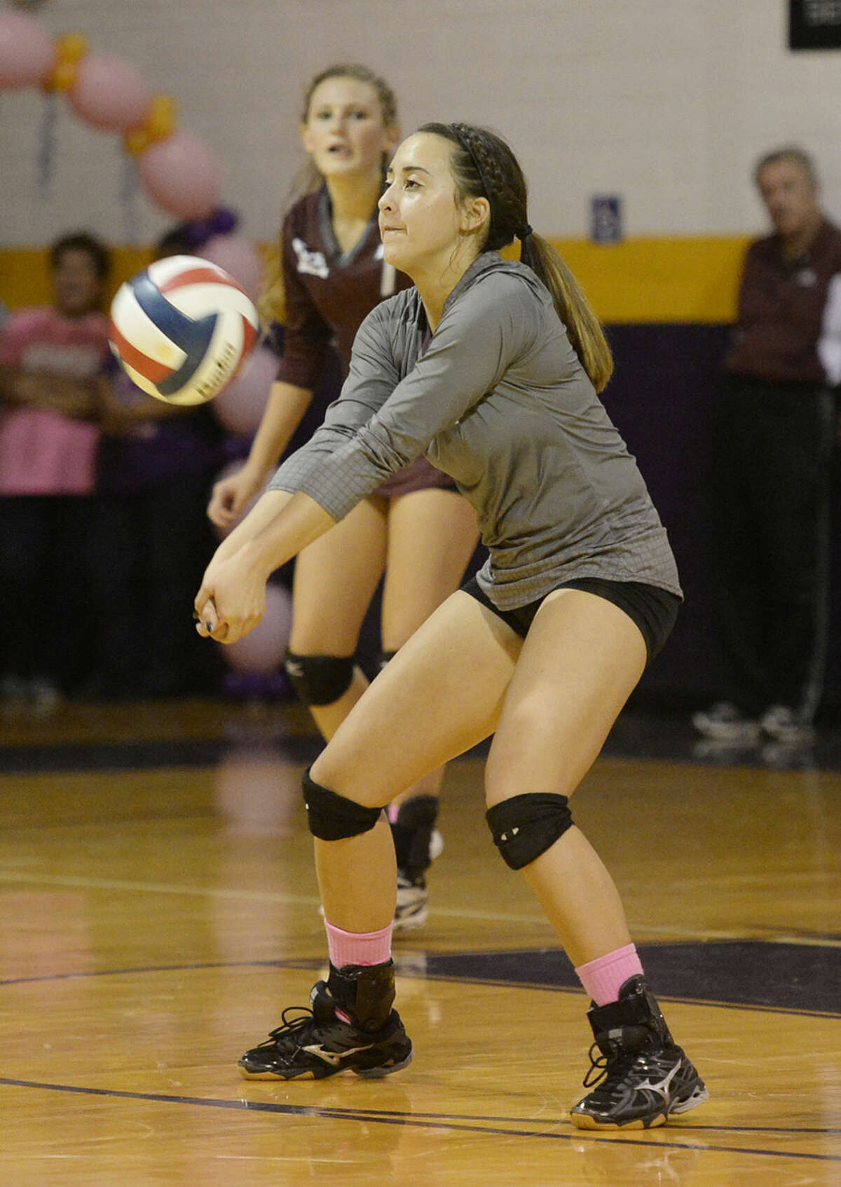 Lee High's Shelby Olivas (4) receives a serve from Midland High on Tuesday, Oct. 20, 2015, at Midland High. James Durbin/Reporter-Telegram