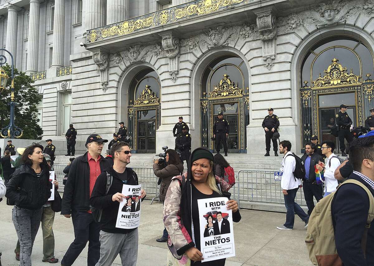 Dozens of people protest outside City Hall in their continued push for the removal of police chief Greg Suhr in San Francisco, Monday, May 9, 2016. Five activists who refused to eat for 17 days, along with their supporters, are holding a peaceful protest at City Hall. The five ended their hunger strike Saturday after they were taken to the hospital. A protest organizer announced at the protest that most of the five will start eating solid food again Monday. (AP Photo/Janie Har)