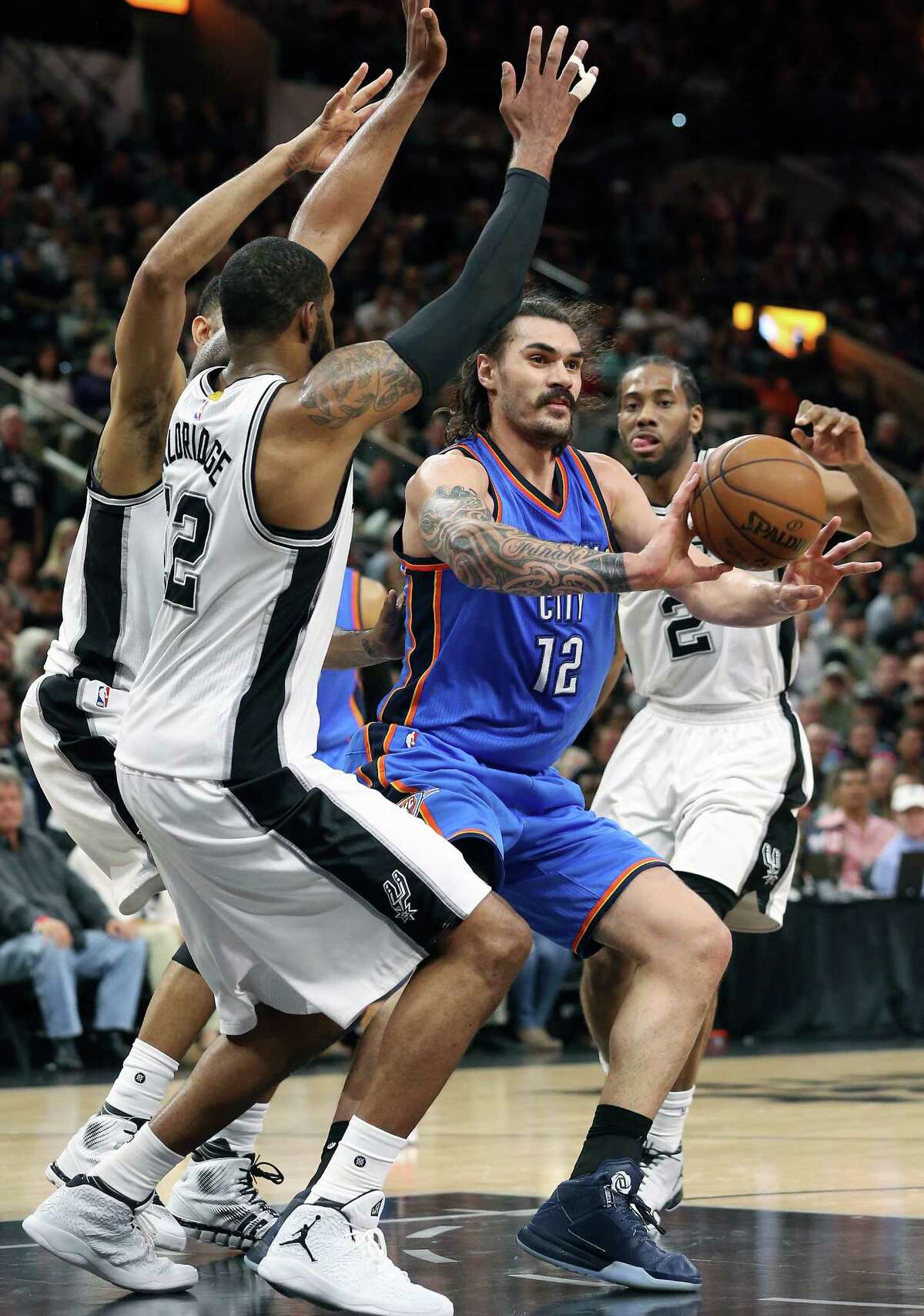 Steven Adams passes to the outside as the Spurs host the Thunder in game 2 of second round NBA playoff action at the AT&T Center on May 2, 2016.