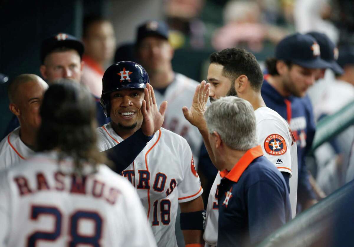 It's been a rough season for Astros third baseman Luis Valbuena (18), but he had a reason to smile Monday night after scoring on Jose Altuve's double in the five-run third inning.