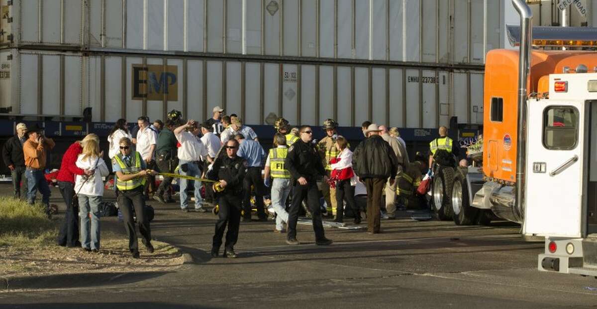 (File Photo) Midland police, fire and sheriffs respond to an accident where a semi trailer carrying veterans in a parade was struck by a train crossing Garfield. Tim Fischer\Reporter-Telegram