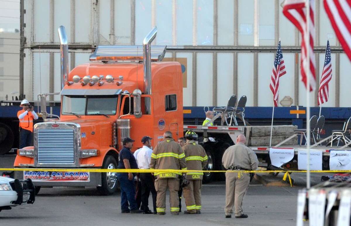 Public safety officers work the scene after a flatbed truck carrying wounded veterans and their families during a parade was struck by a train Nov. 15, 2012, on Garfield in Midland. James Durbin/Reporter-Telegram